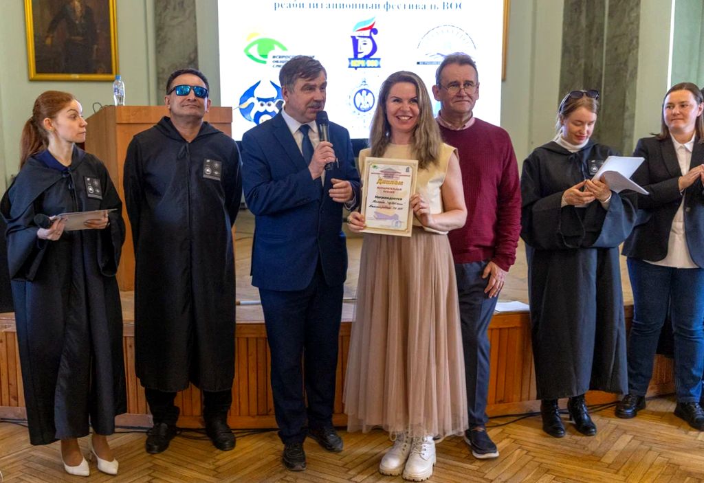 Церемония награждения; представительница Калининградской РО ВОС с дипломом, члены оргкомитета фестиваля и ведущие площадок.