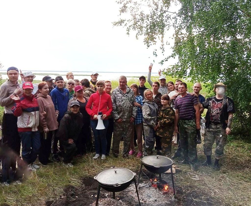 Участники мероприятия у костра. Над костром висят 2 казана.