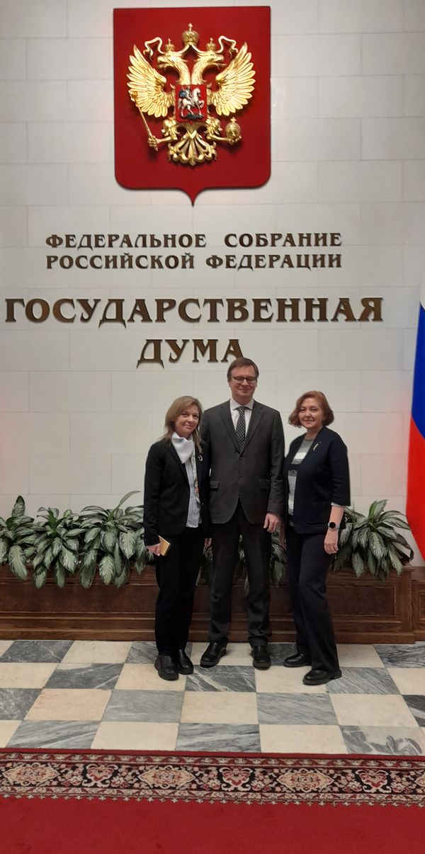 Представители аппарата управления ВОС на фоне символики Государственной Думы перед входом в Малый зал